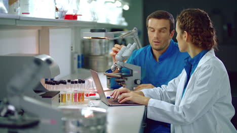 Laboratory-researchers-in-lab.-Lab-research-team-doing-research-microscope
